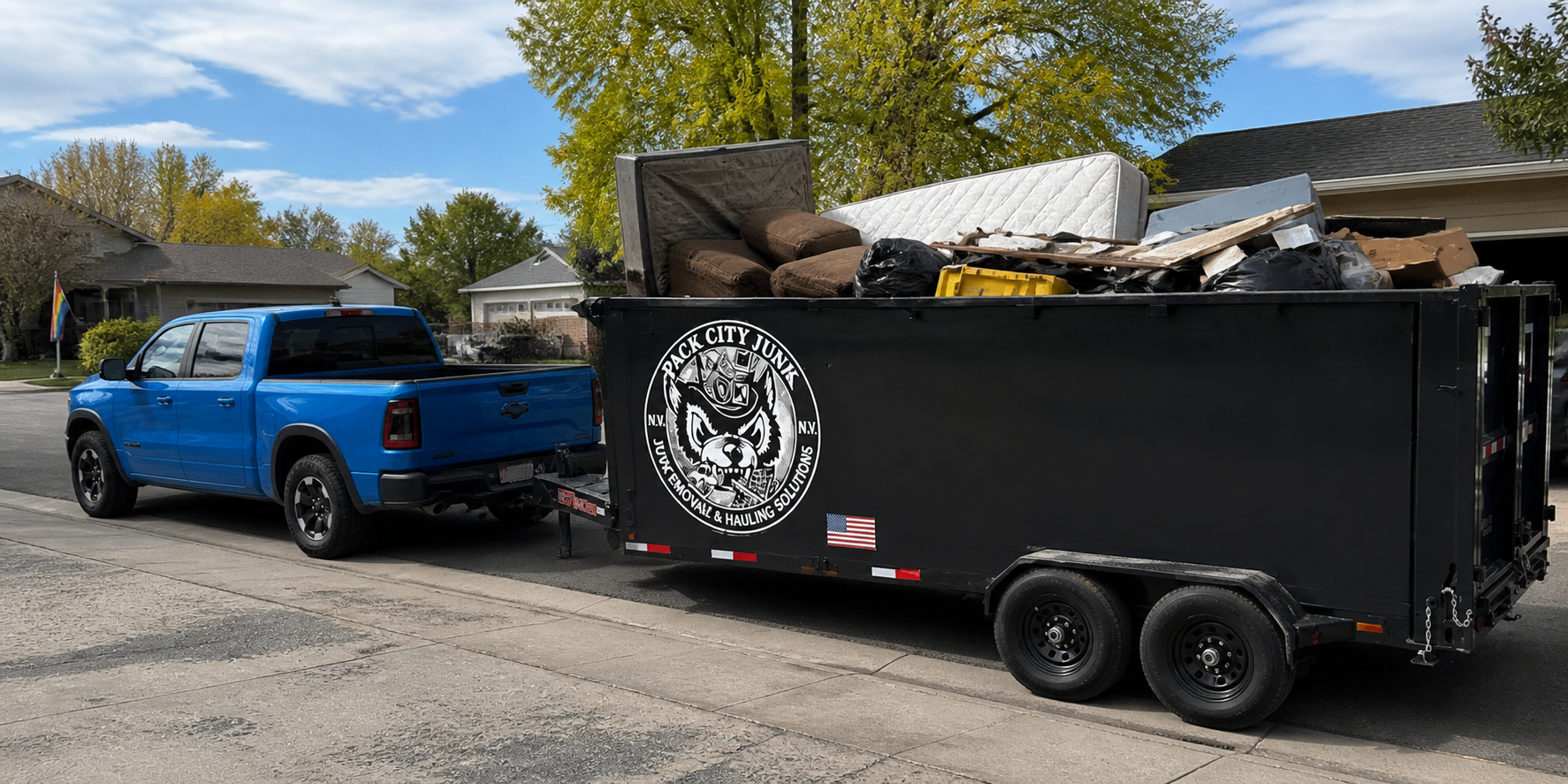 Pack City trailer fully loaded with mattresses, bags and household debris after a cleanout